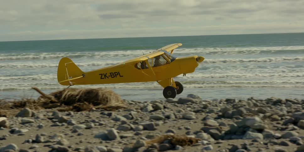 A plane begins takeoff on the shore