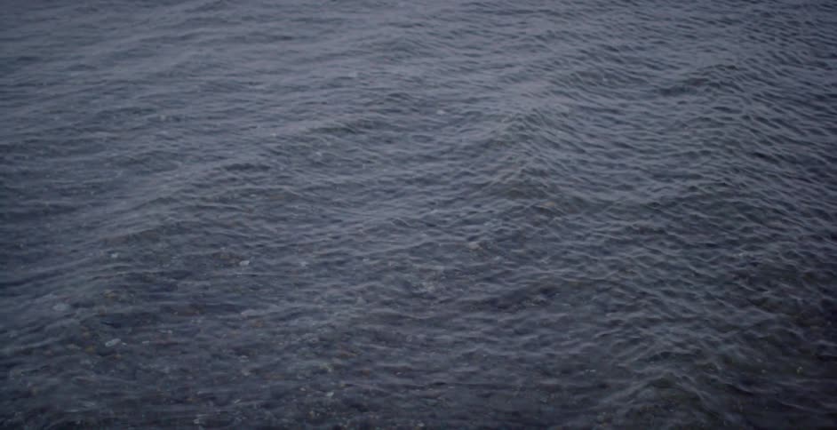 Gentle waves roll in water