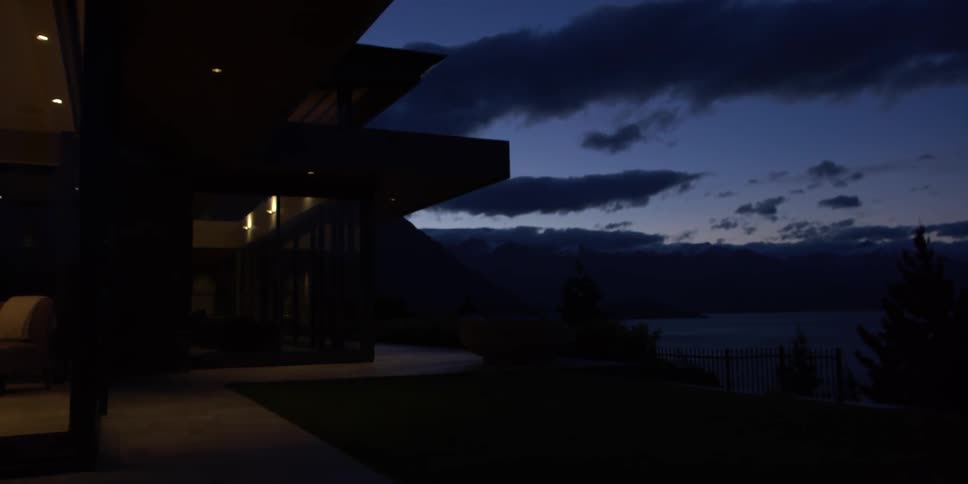 A man walks in his living room at dawn
