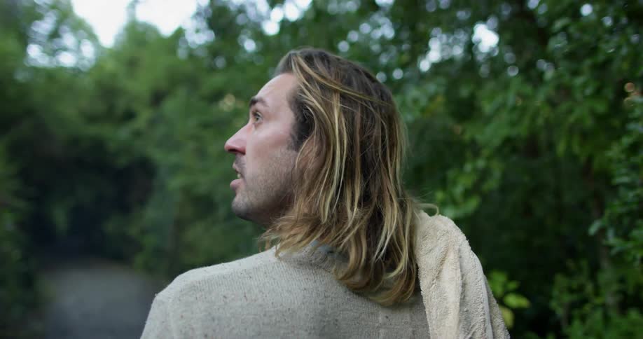 A man walks in a forested area