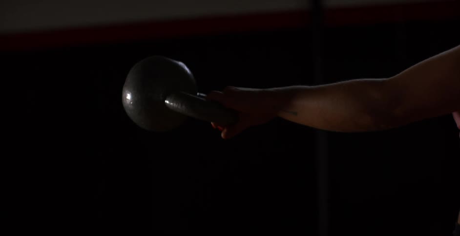 A woman works out using a kettlebell