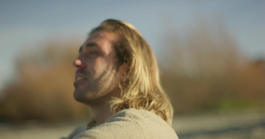 A man looks up at the bright sky