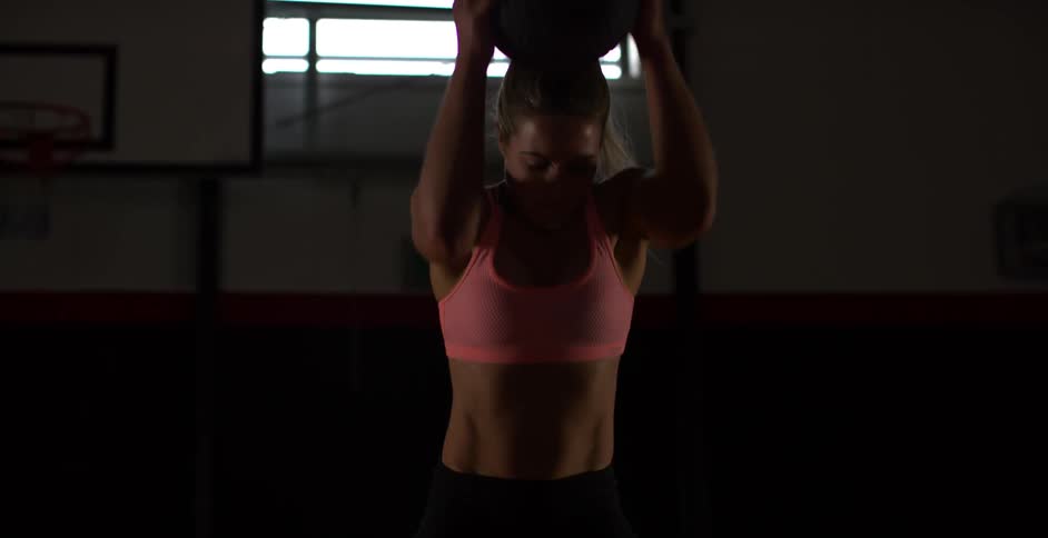 A woman exercises with a ball