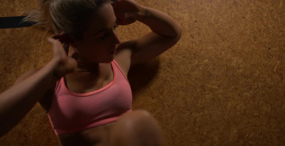 A woman is exercising on the floor