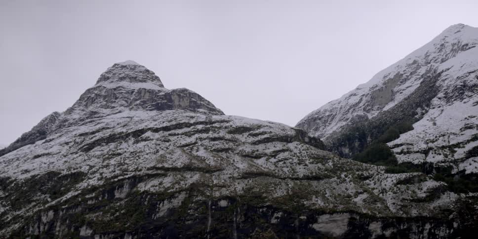 The mountain is covered with light snow