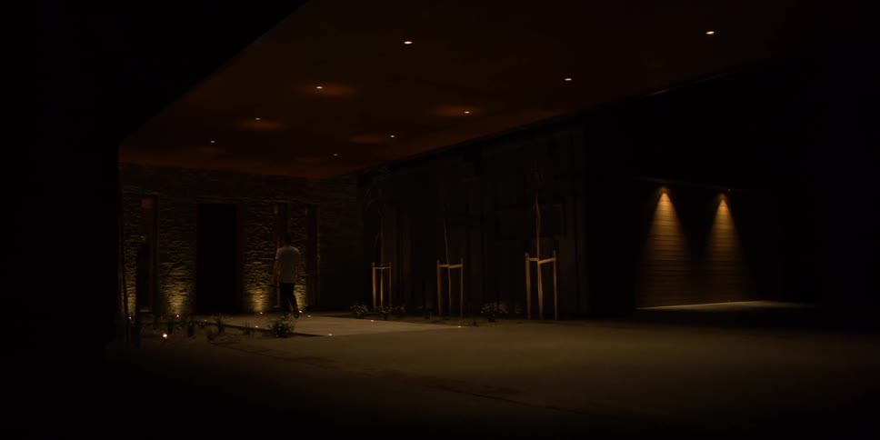 A man walks in a dimly lit area