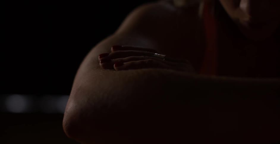 A woman sits with her arms crossed