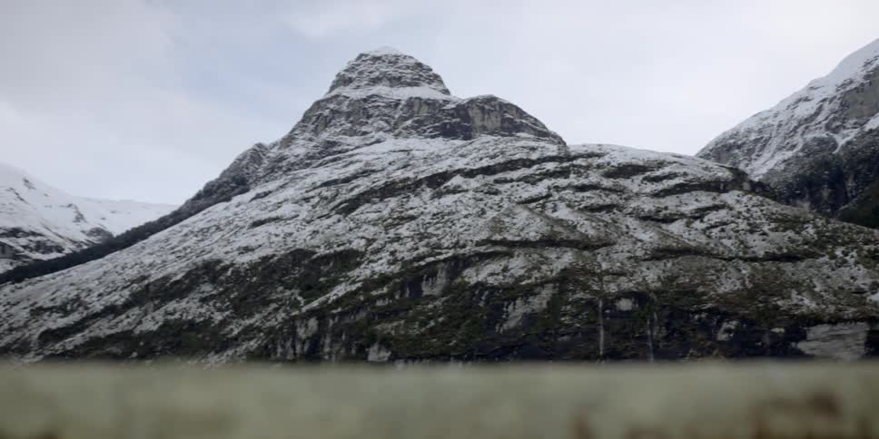 Snow covers a rocky mountainside