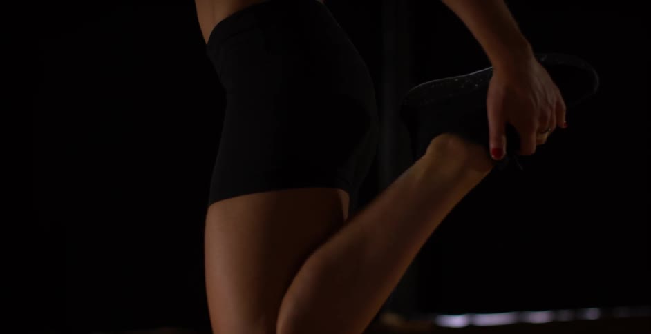 A woman kicks her leg back