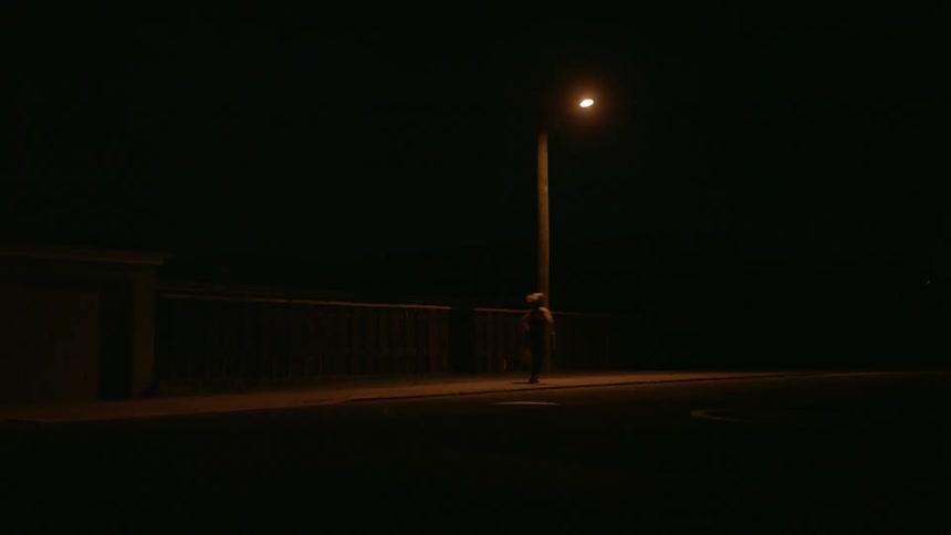 Person running by a street light at night