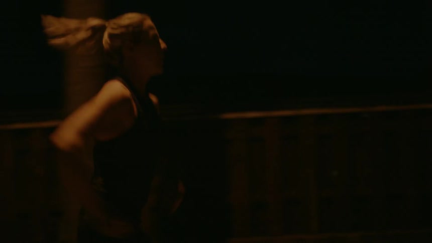 Woman running outside in a dim street light