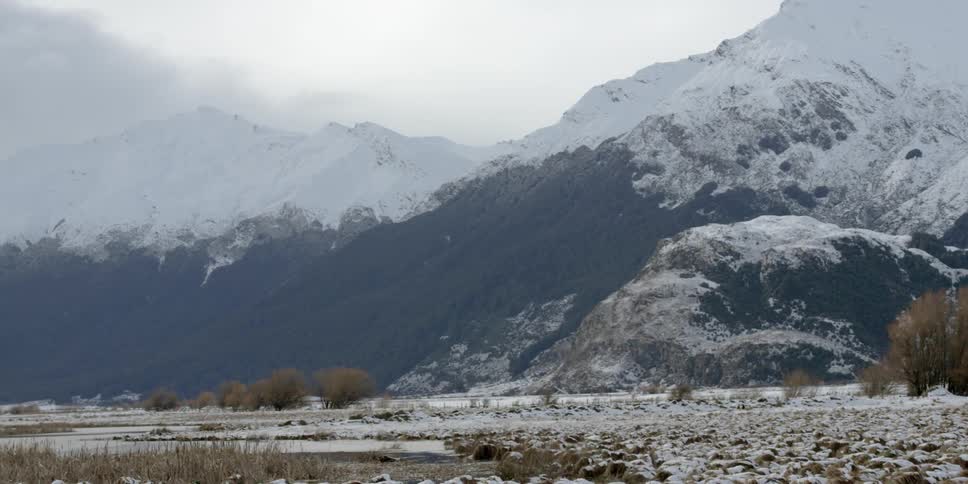 The ground and mountain are covered with ice and snow