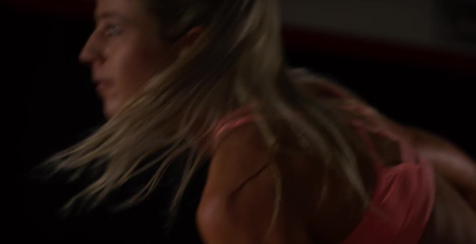 A woman is exercising with a kettlebell