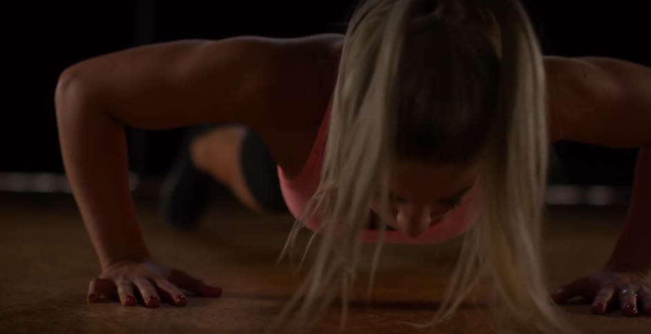 A woman is doing push ups