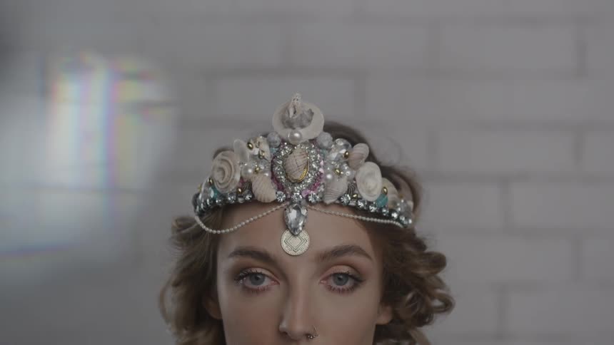 A woman wears an ornate tiara