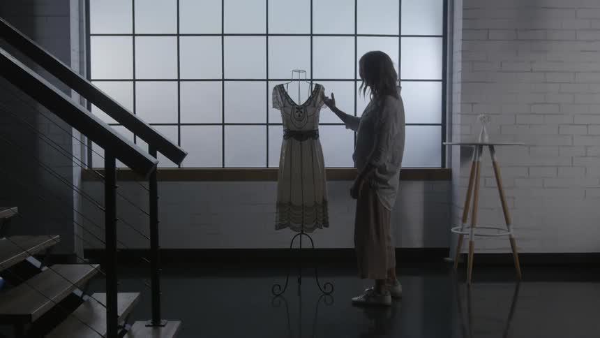 A woman examines a dress