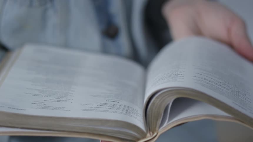 A person opens a book