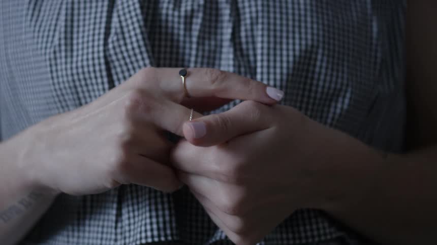 Person wrings their hands together