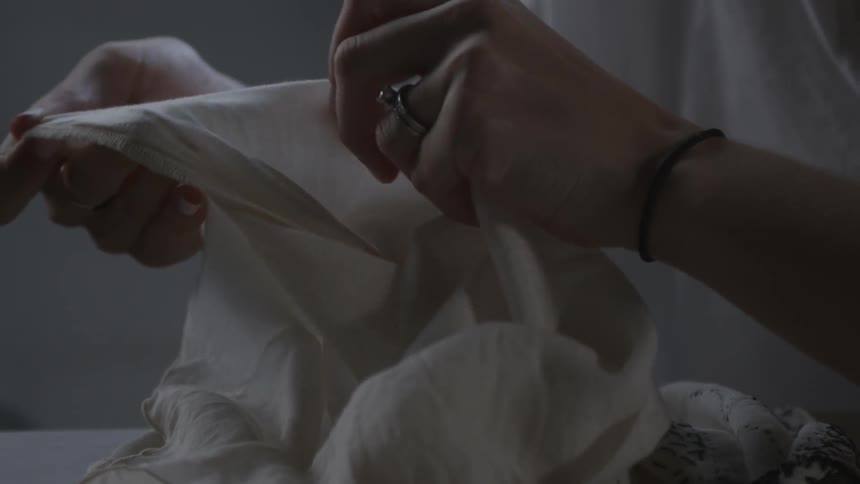 A woman is looking at some fabric
