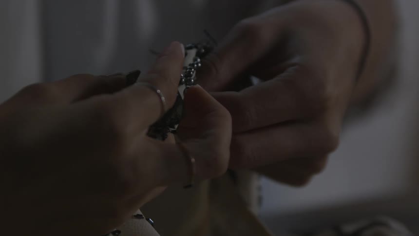 A woman is sewing fabric