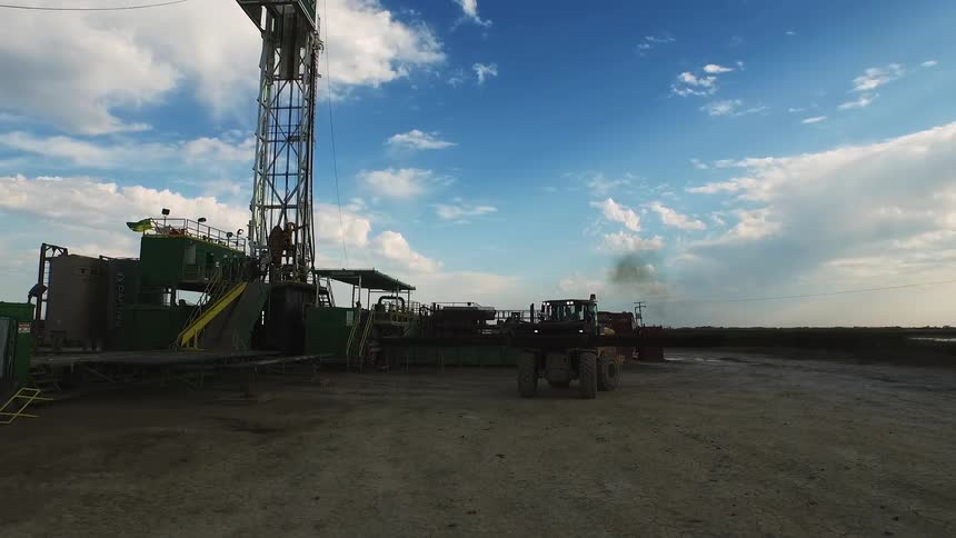 A construction vehicle rides along the work site