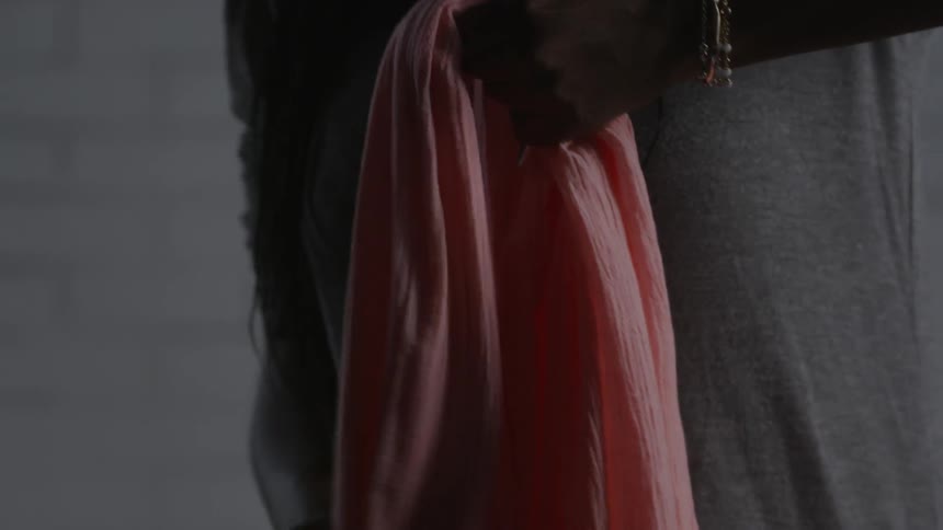 A woman is holding a pink cloth