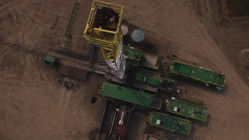 A work site has buildings and a tall tower