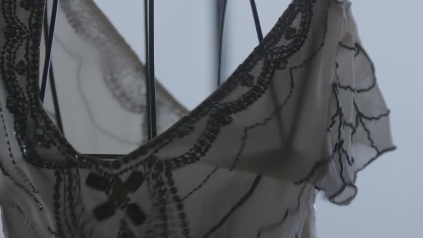 A blouse is placed on a wire mannequin