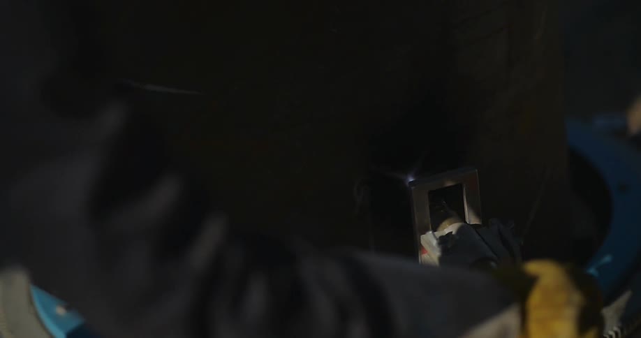 A worker turns off a flaming tool
