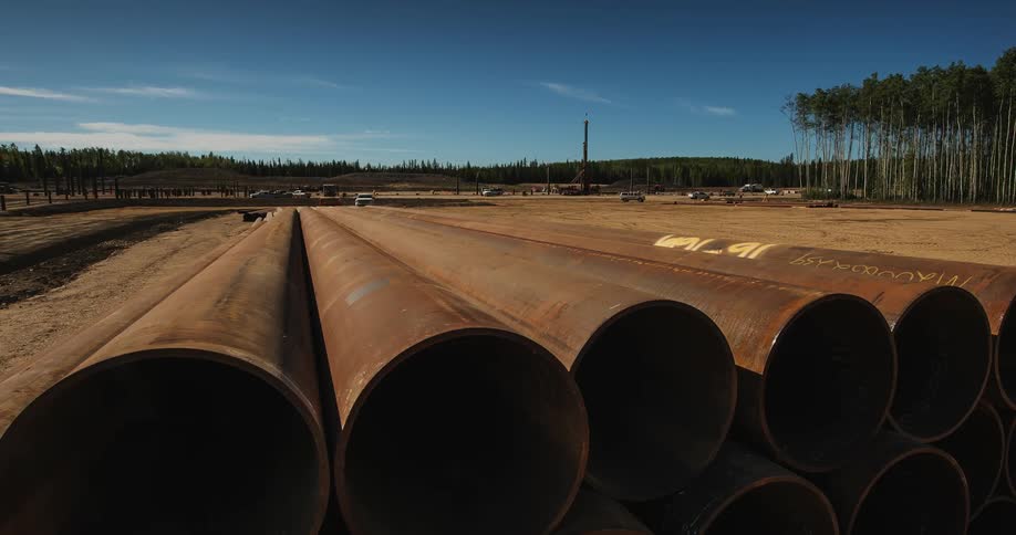 Large metal tubes outside in a field