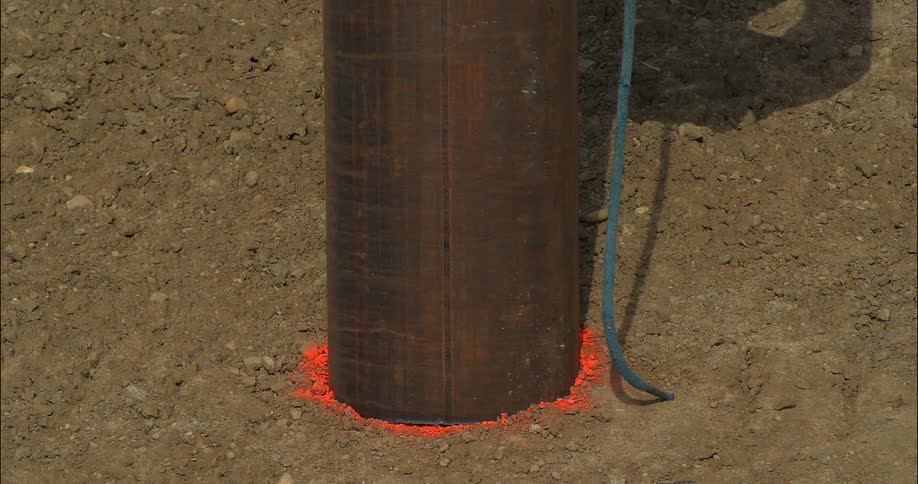 Metal pipe is set on a red chalk circle