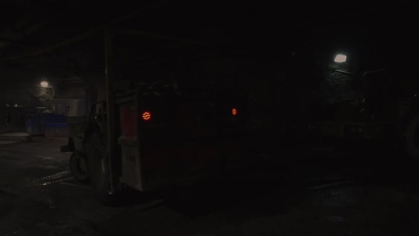 A truck slowly moves in the dark