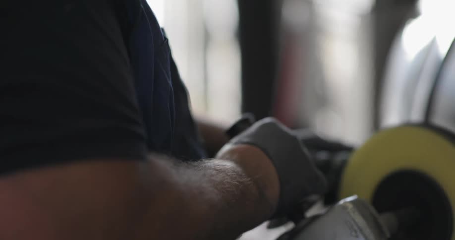 A man holds a rotating power tool