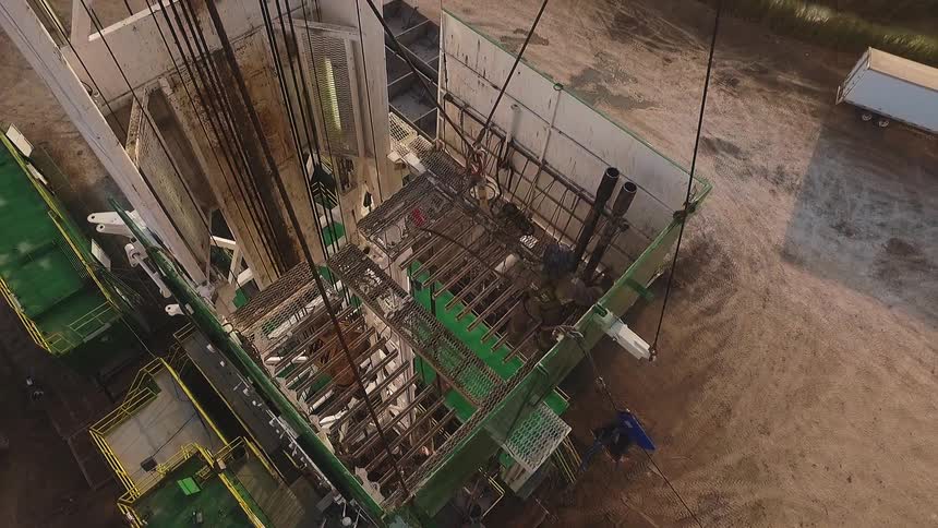 A worker is pulling ropes on a crane