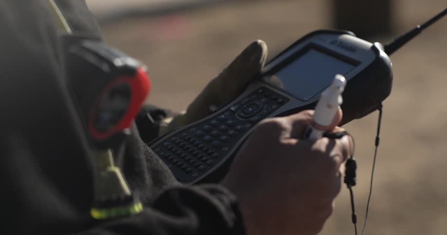 A worker is using a handheld device