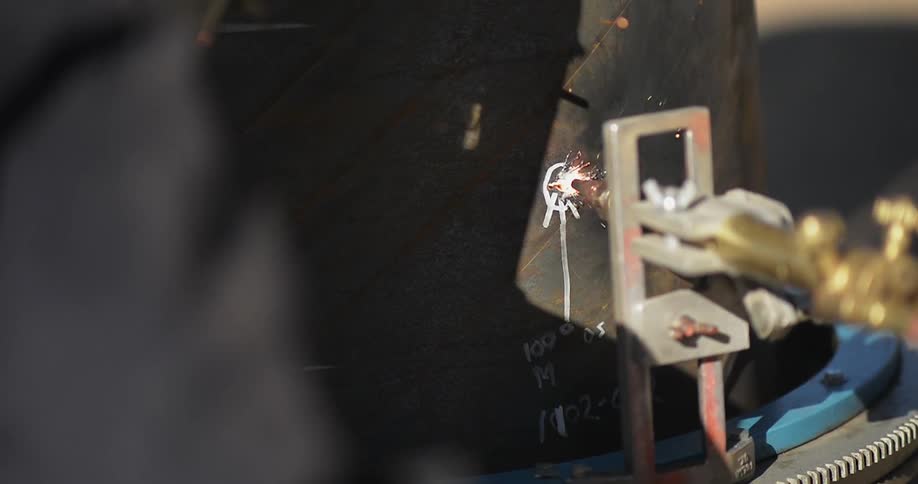 A tool is being used on a piece of metal