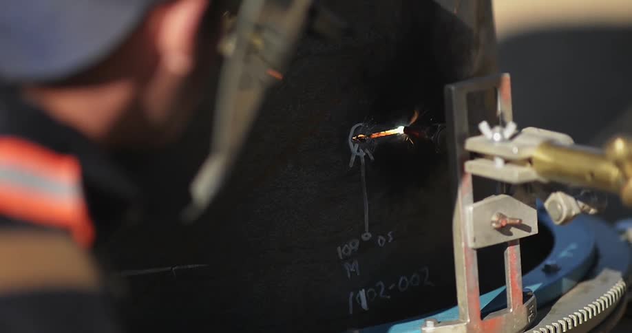 A man is welding with a small welder