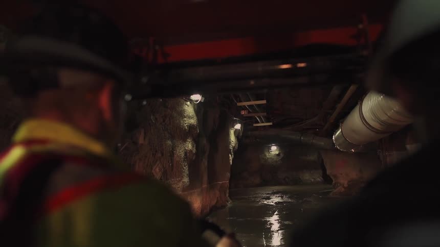 Man drives a vehicle through a dim tunnel