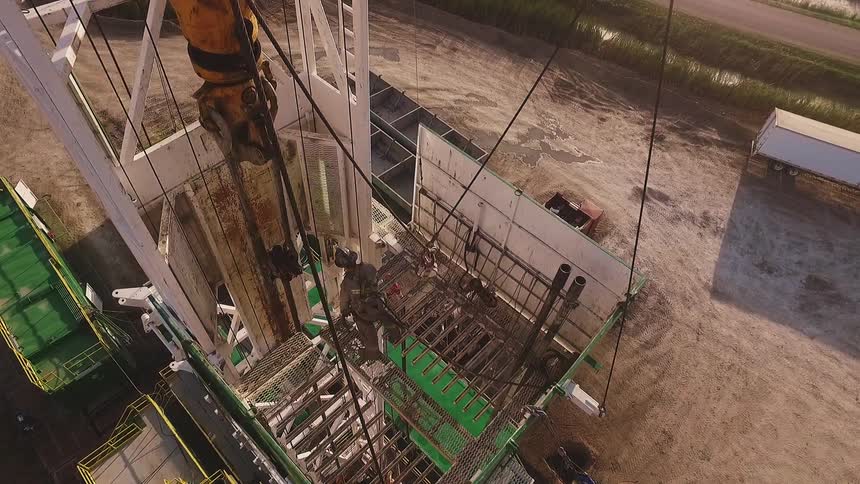 A man guides a wire on a lift