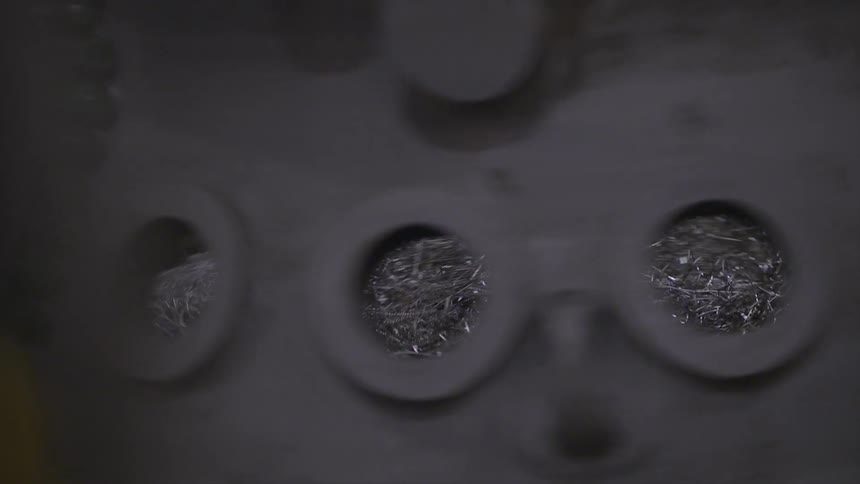 Large metal wheel with holes in it