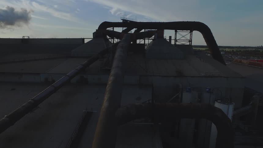 Steam rises from a chimney on the work site