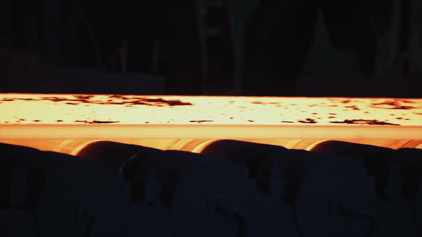 A conveyor belt is moving a hot substance
