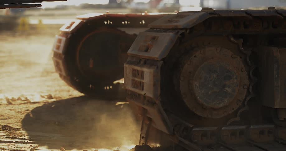 A construction vehicle moves in the dirt