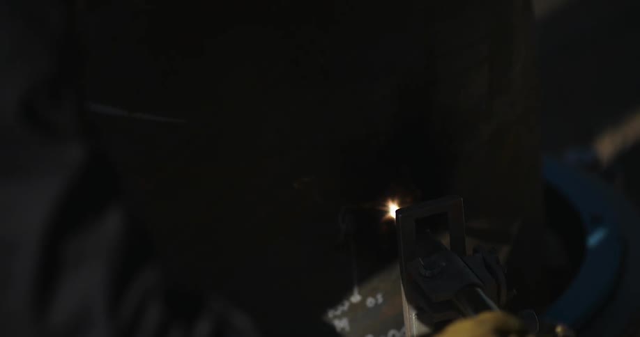A person is welding a piece of metal
