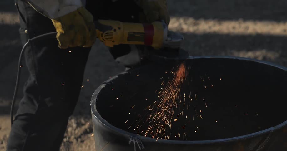 A man is sawing a metal tube