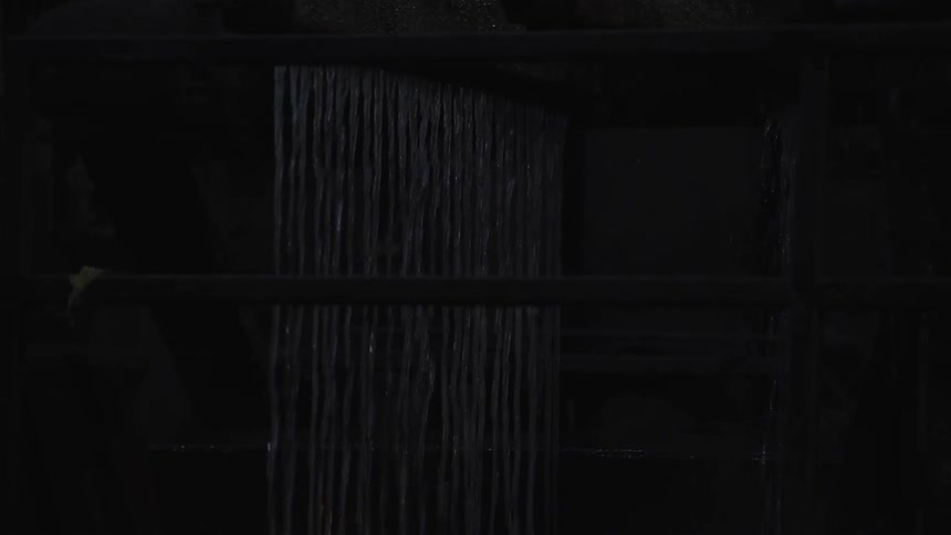 Water splashing in a dimly lit room