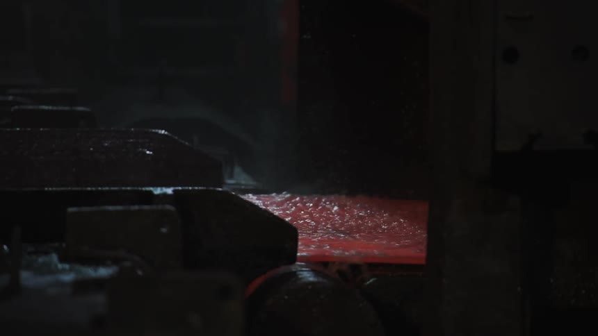 Water pours over a hot conveyor belt