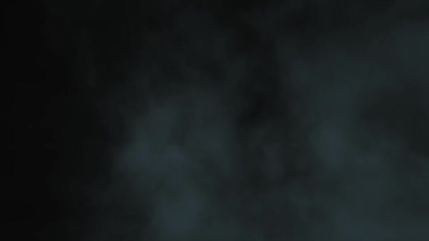 Smoke slowly rises in the dark