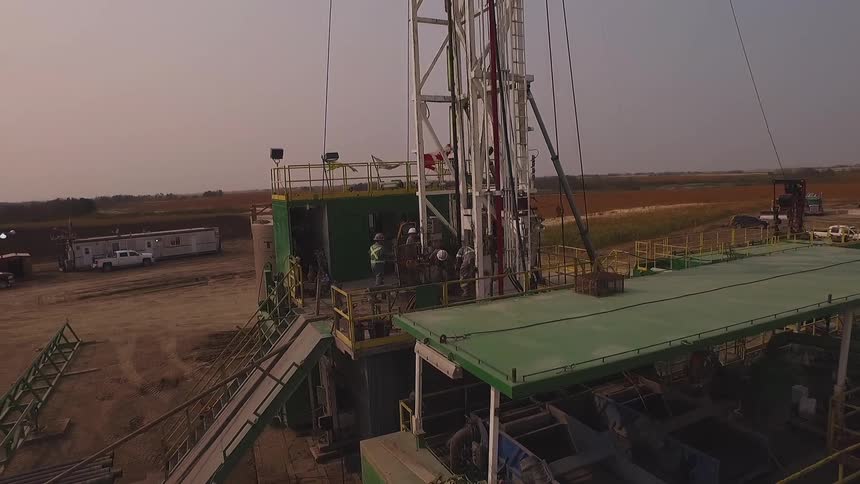 The work site has many people near a crane