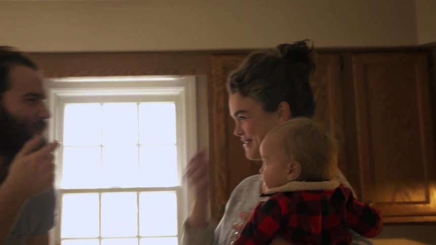 A family plays around in the kitchen